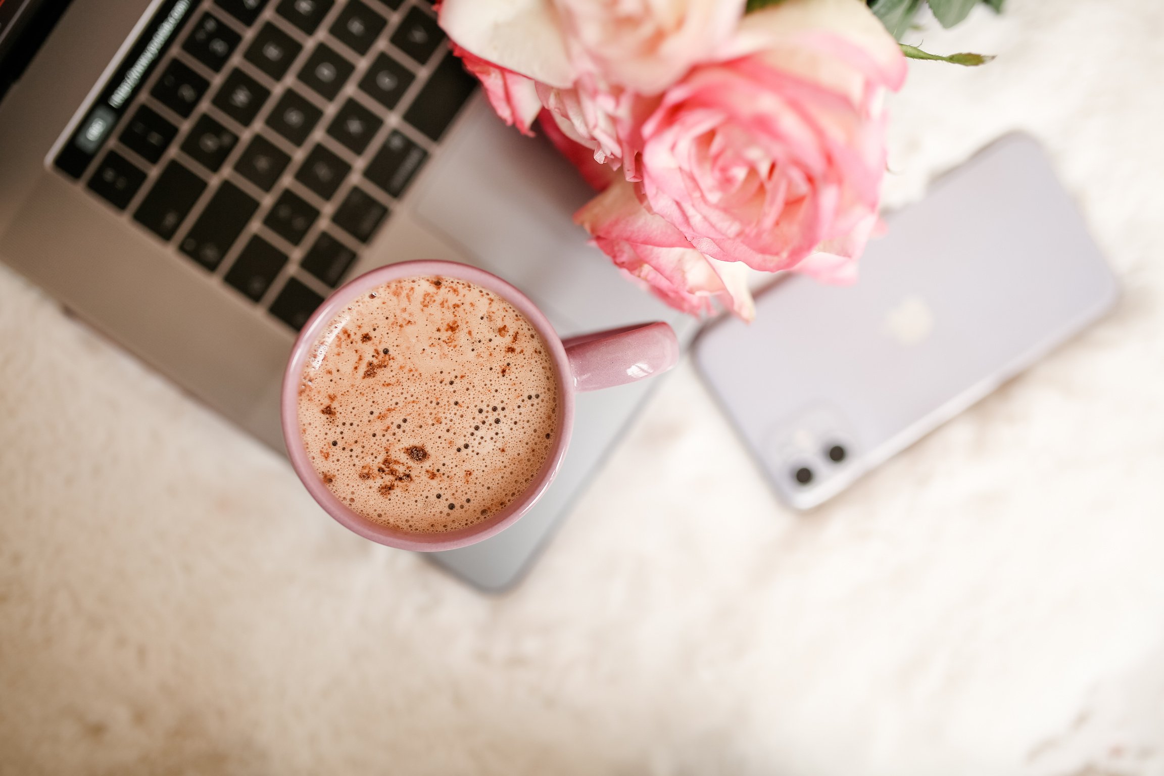 Top View of Chocolate Drink and Pink Roses on Laptop 